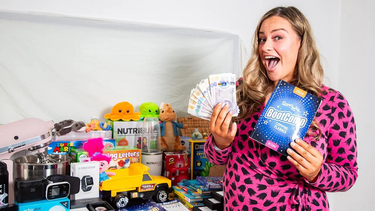 Woman holding coupons and standing next to prizes.
